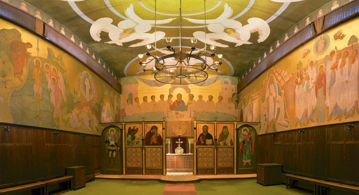 Mural-filled Orthodox church interior with angelic ceiling art