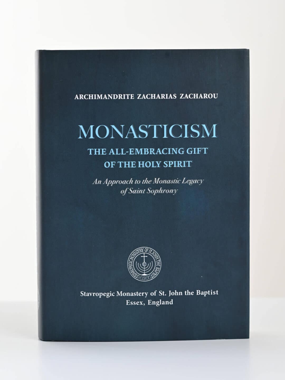 Dark blue book titled "Monasticism: The All-Embracing Gift of the Holy Spirit" by Archimandrite Zacharias Zacharos