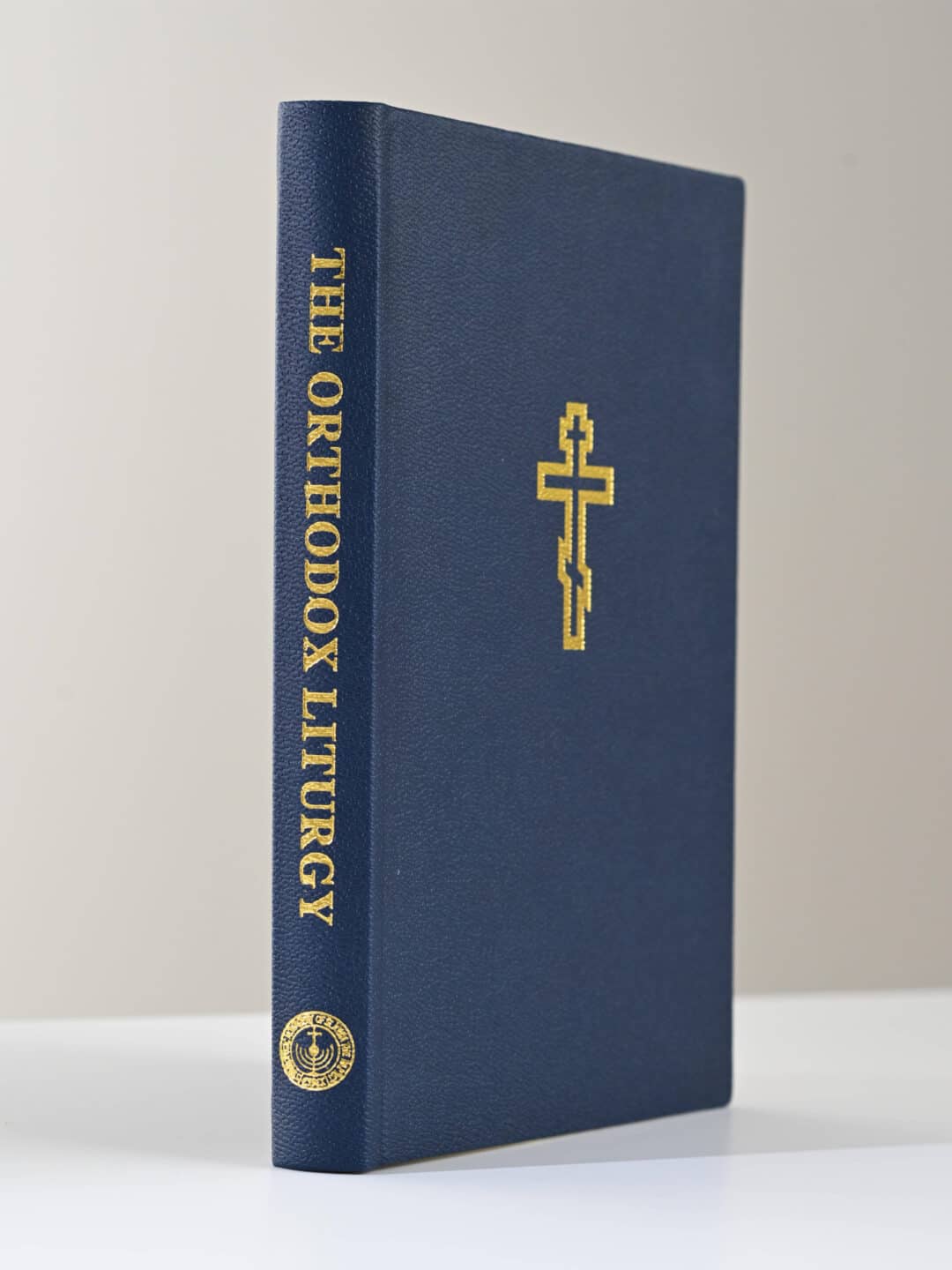 The Orthodox Liturgy book with gold cross and text