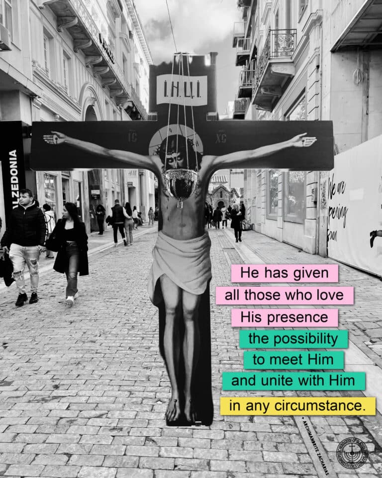 Crucifixion art on a street, with text about meeting Him.
