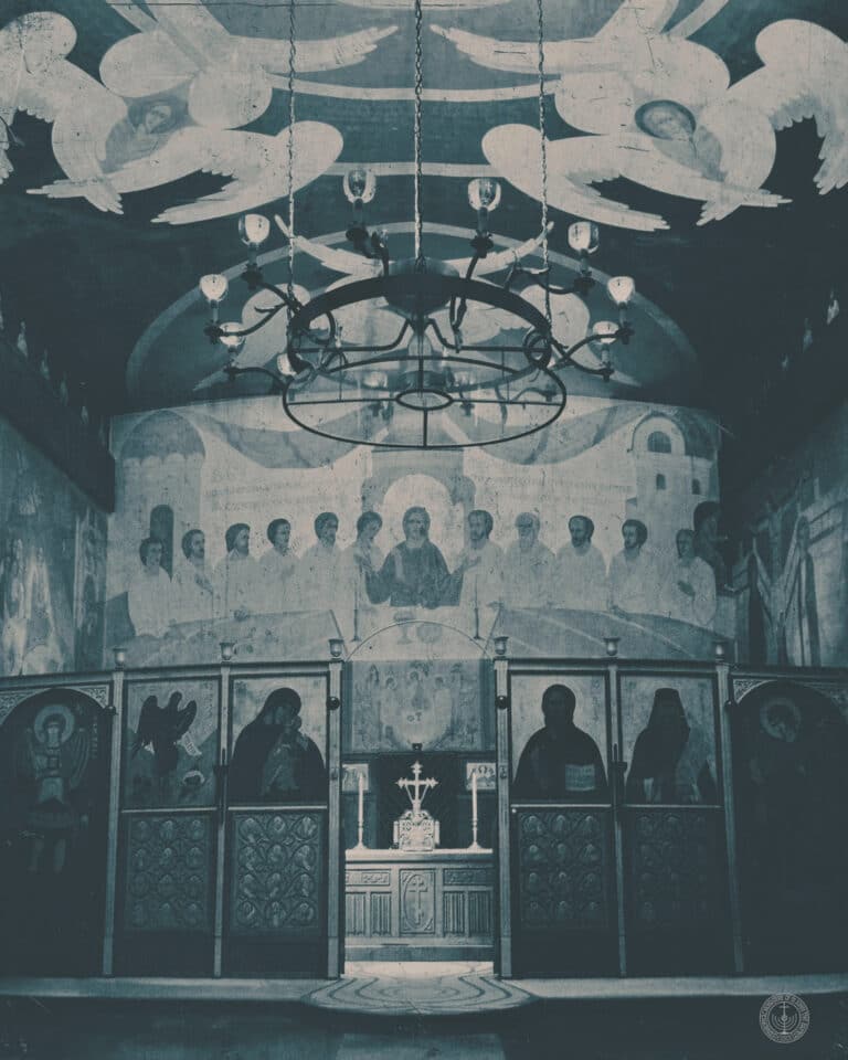 Interior of a Byzantine church with frescoes, icons, and chandelier