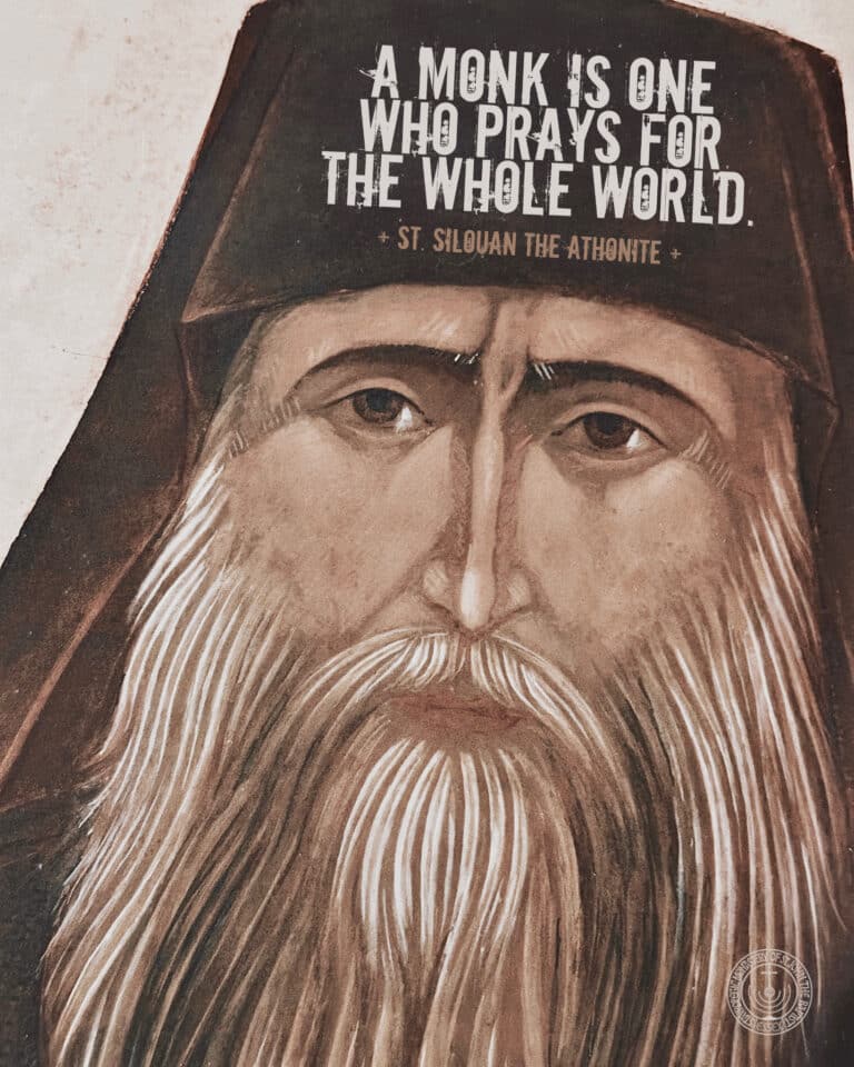 Mural of a monk with a long beard, quoting St. Silouan the Athonite: "A monk is one who prays for the whole world.