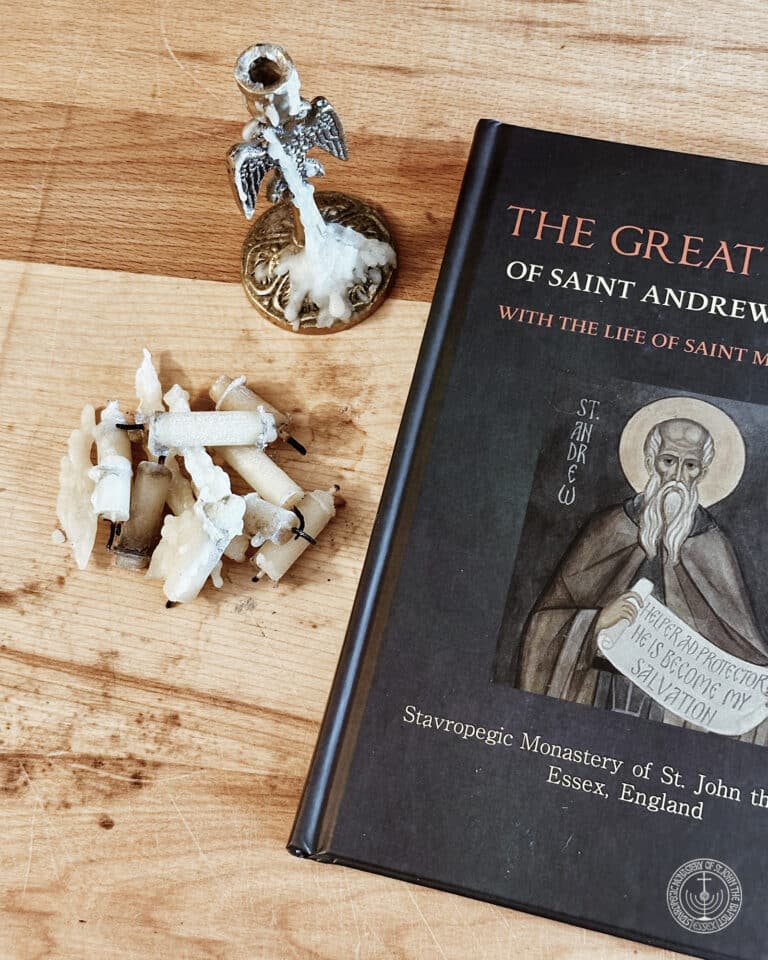 Book cover "The Great Canon of St Andrew" with used candles and a candle holder.