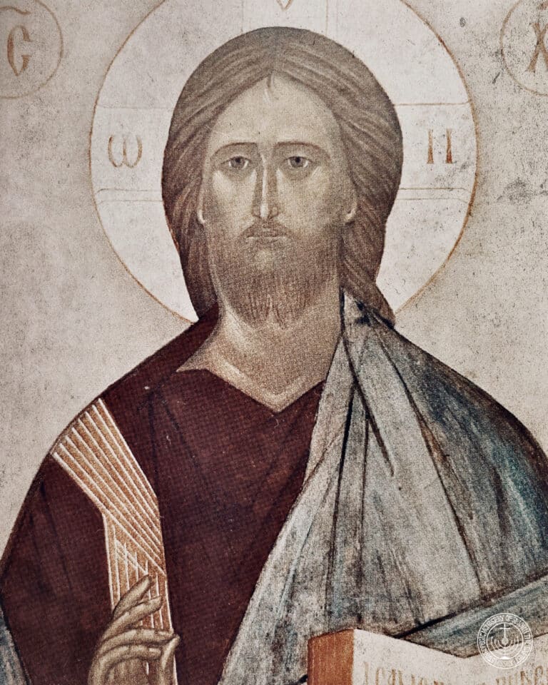 Icon of Jesus Christ with halo and Greek letters, holding a book