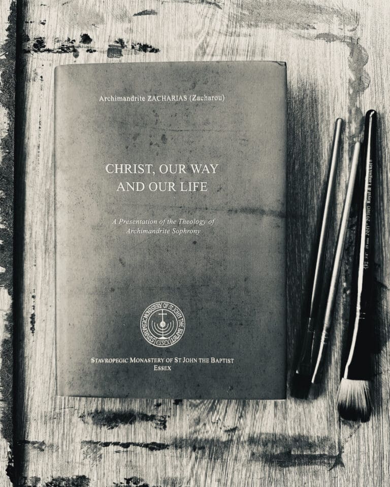 Book "Christ, Our Way and Our Life" by Archimandrite Zacharias, with paintbrushes